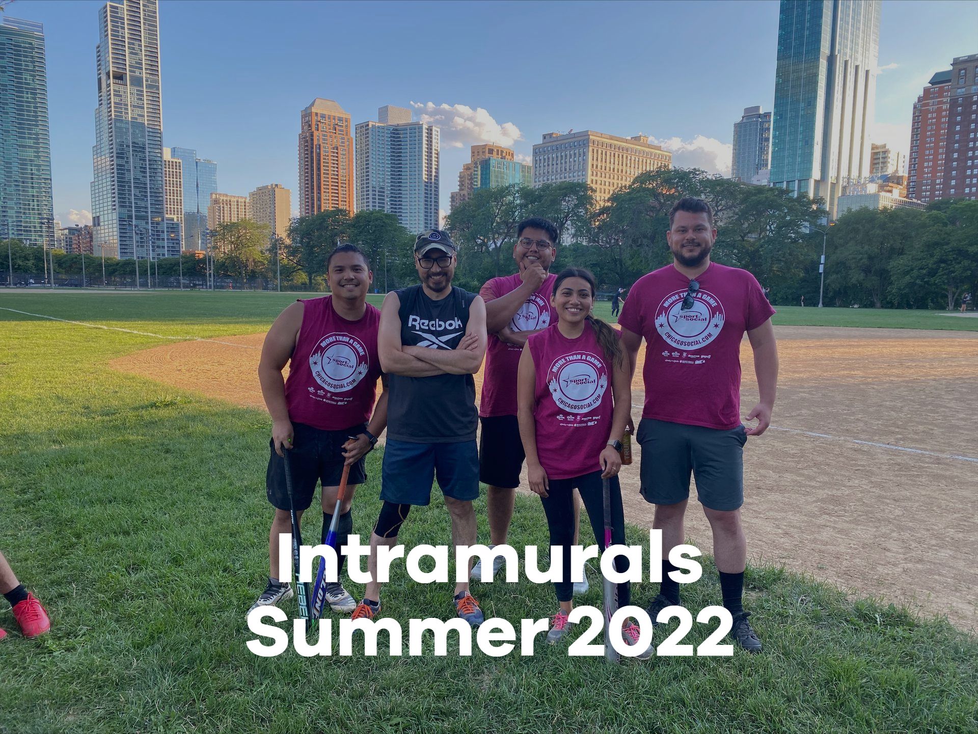 A group of people are posing for a picture in a field.