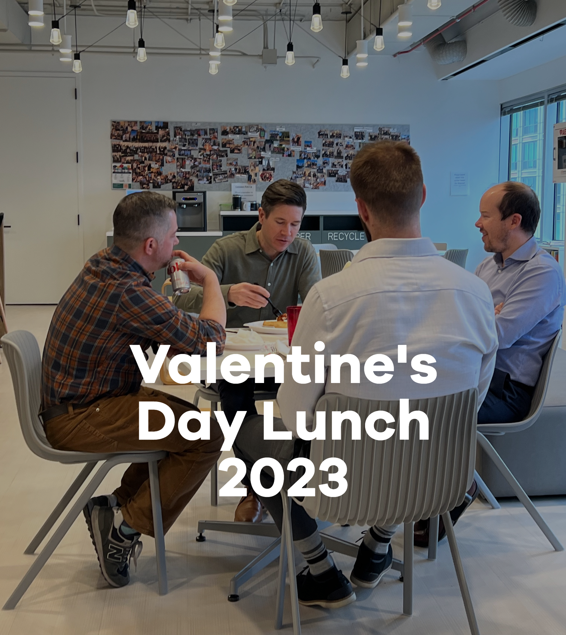 A group of men are sitting around a table for valentine 's day lunch in 2023