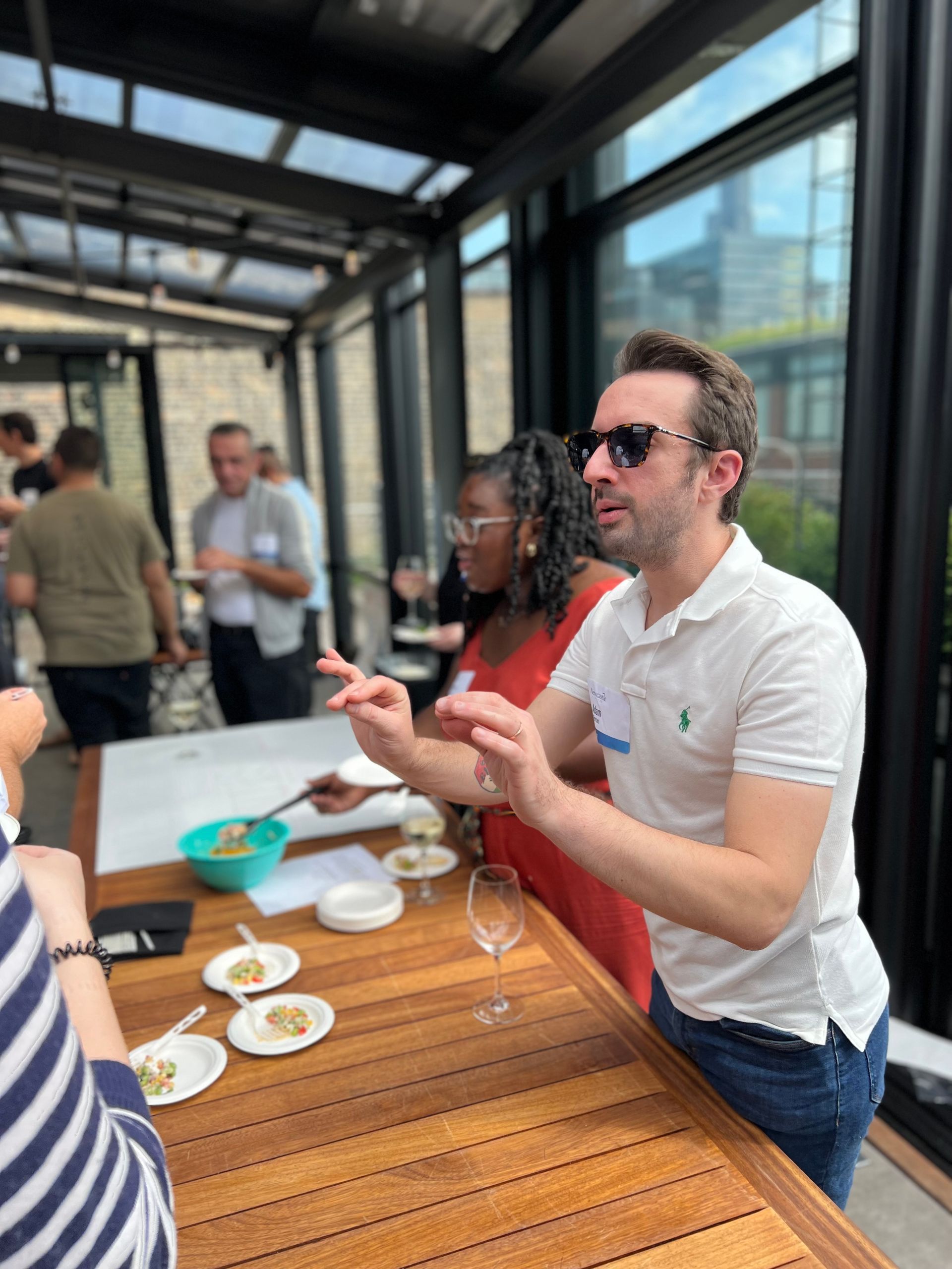 A man and a woman are sitting at a table talking to each other.