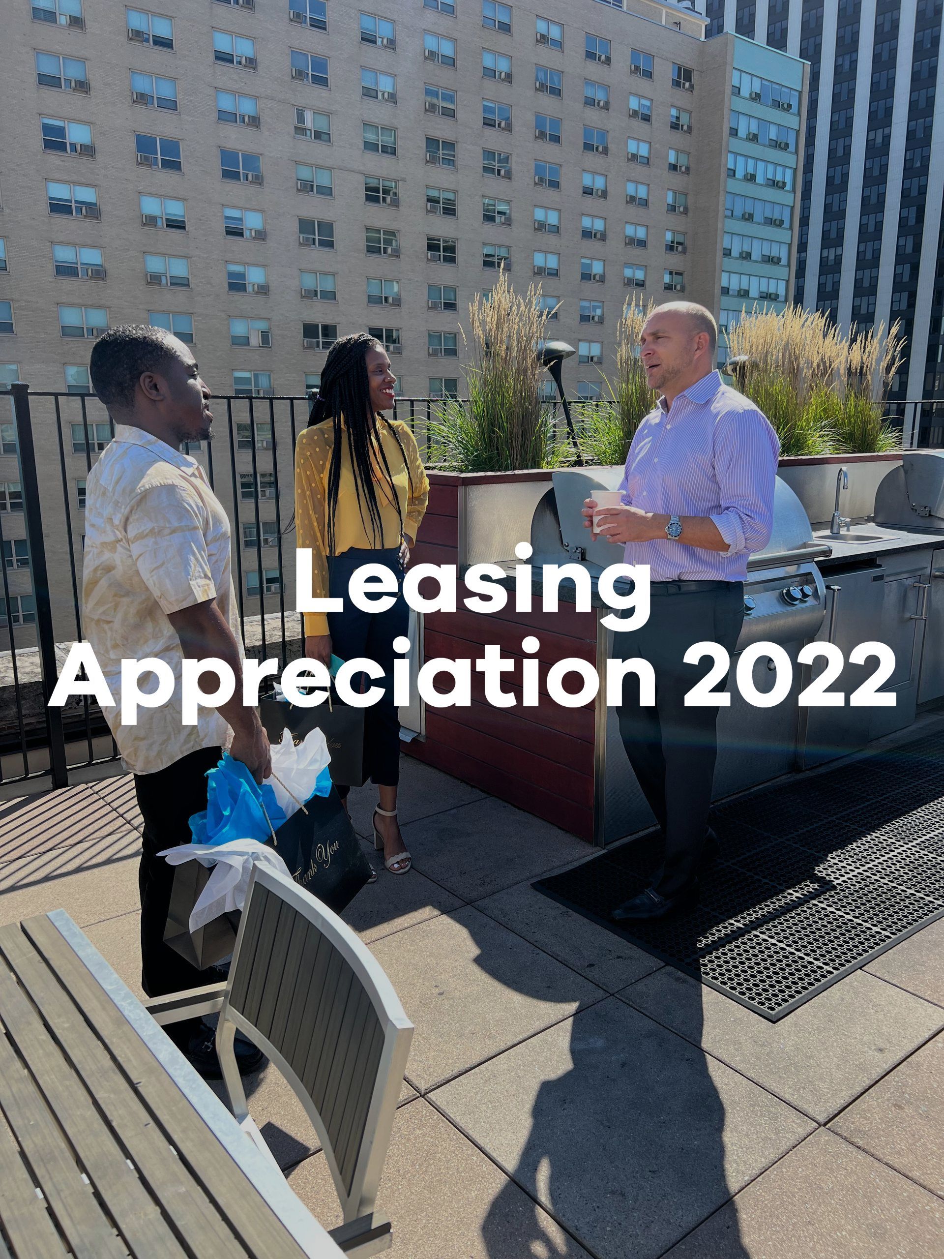 A group of people are standing on a rooftop talking to each other.