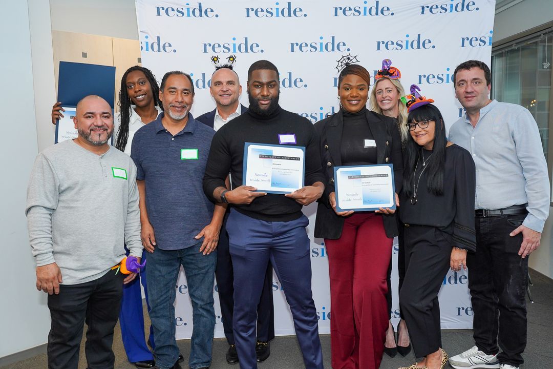 A group of people standing next to each other holding certificates.