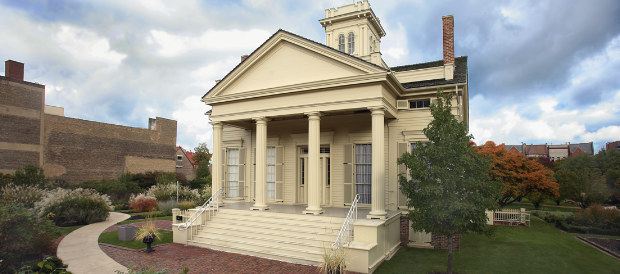 A large white building with columns and a tower on top of it.