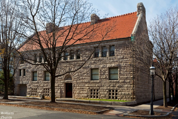 A large stone building with a red roof