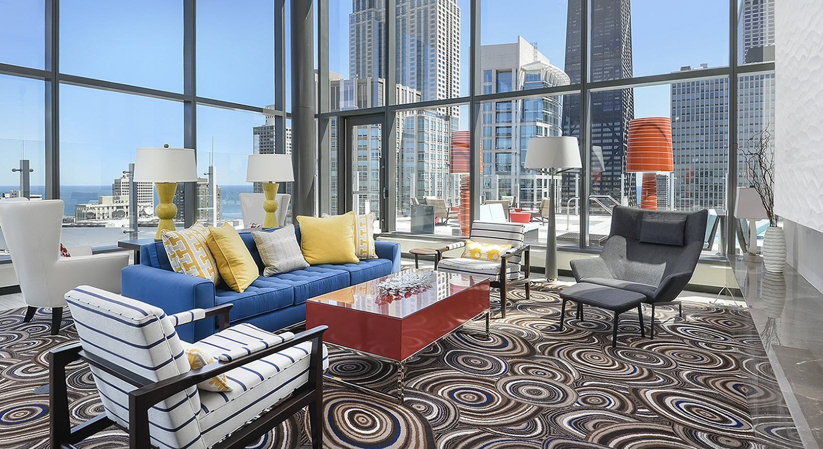 A living room with a couch , chairs , and a coffee table.