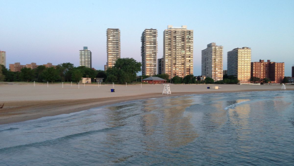 A beach with a city skyline in the background