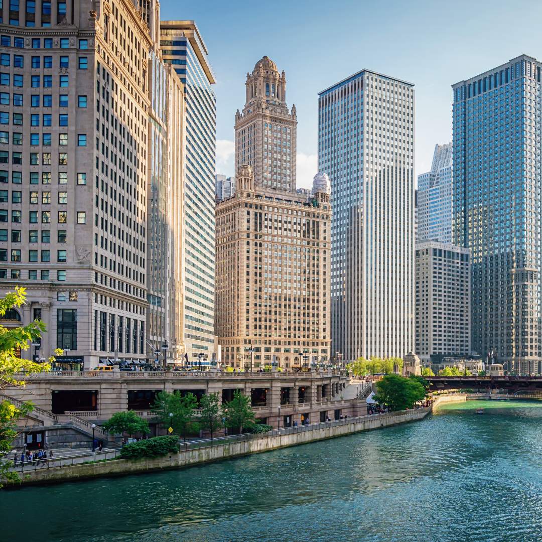 A city skyline with a river in the foreground and a bridge in the background in Chicago.