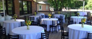 A patio with tables and chairs set up for a party.
