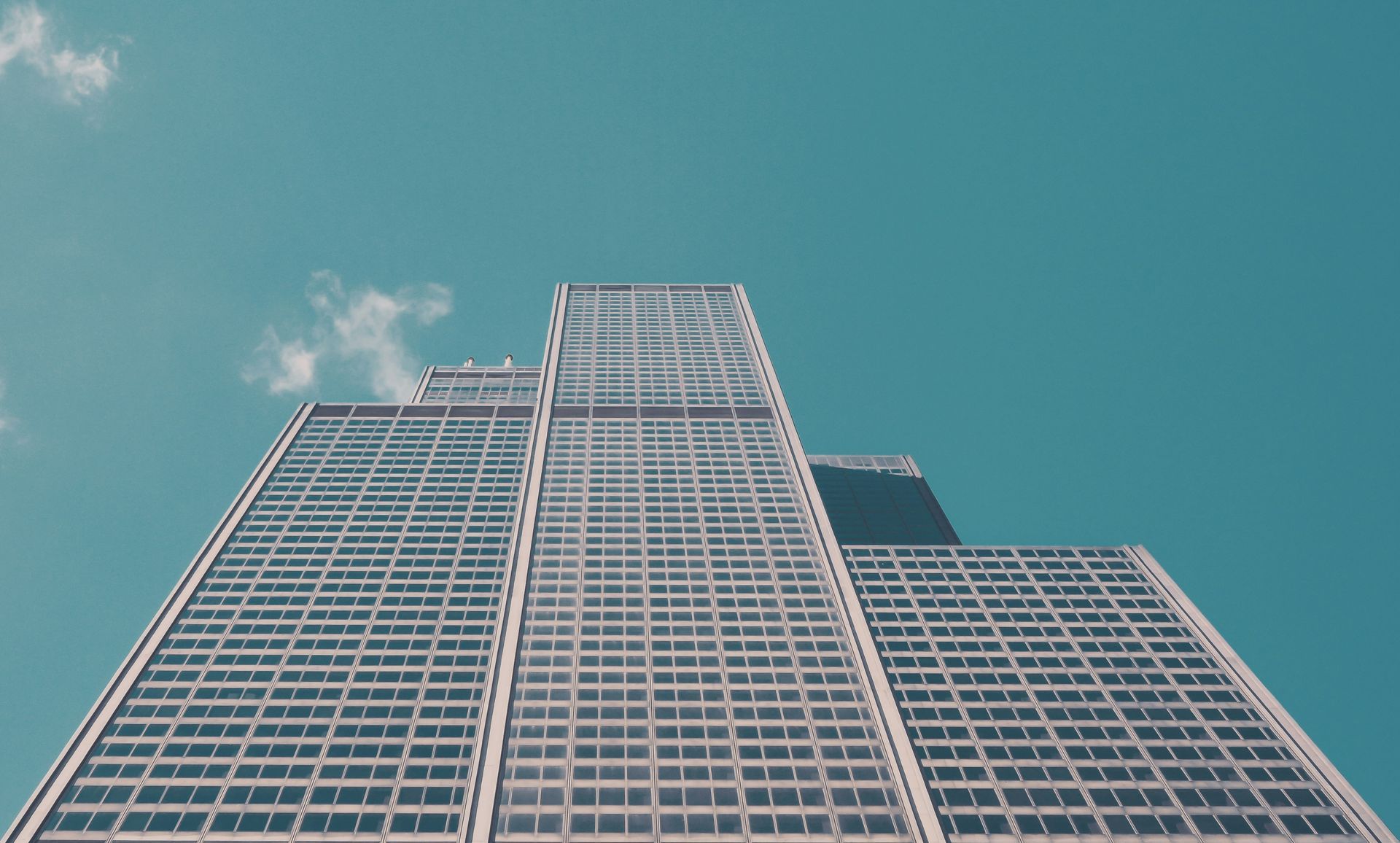 Looking up at a tall building with a blue sky in the background.