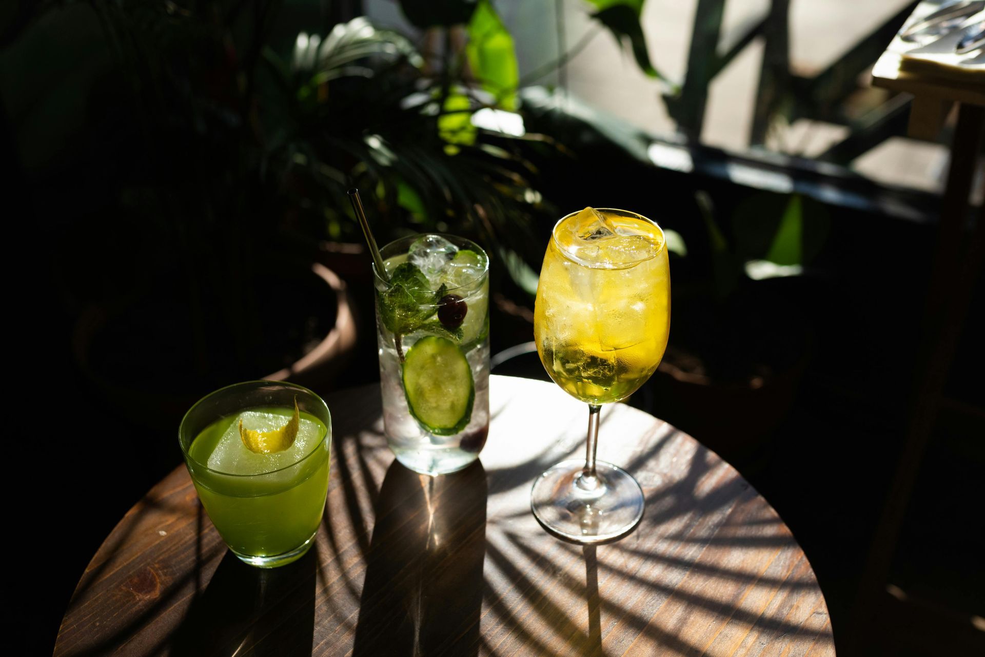Three drinks are sitting on a wooden table.