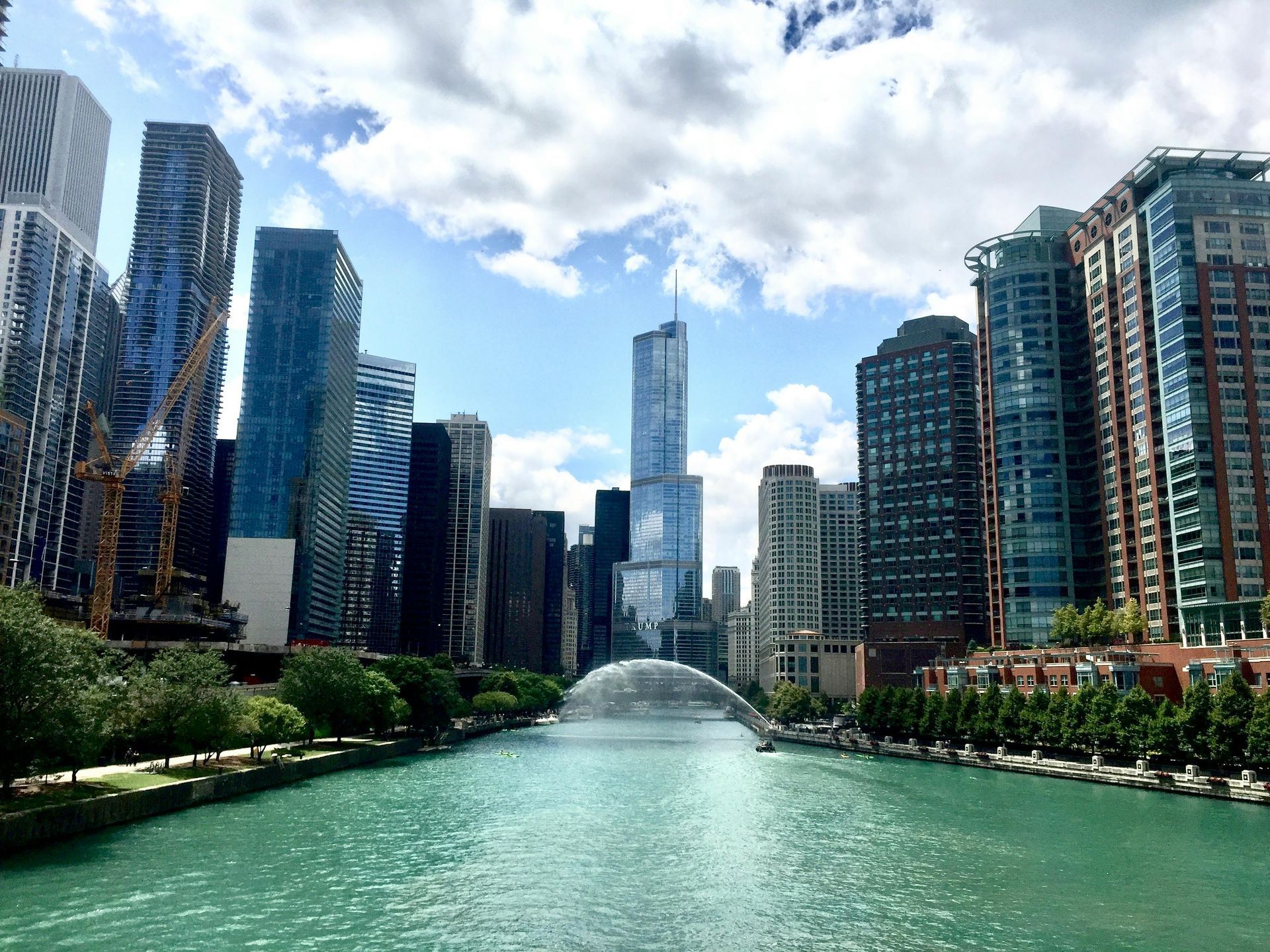 A river running through a city with a fountain in the middle.