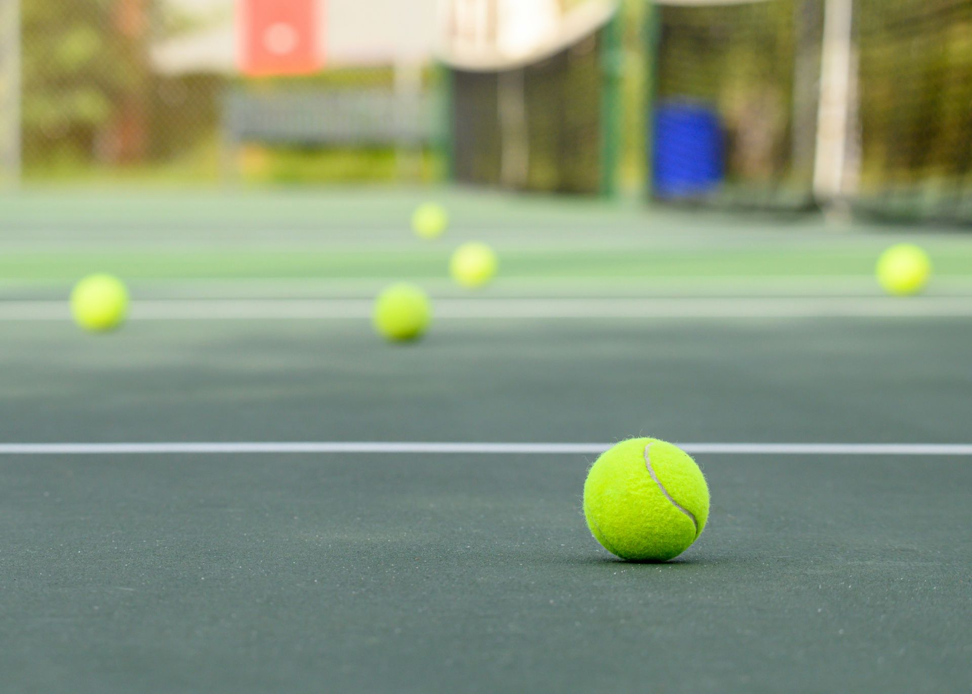 A close up of a tennis ball on a tennis court.