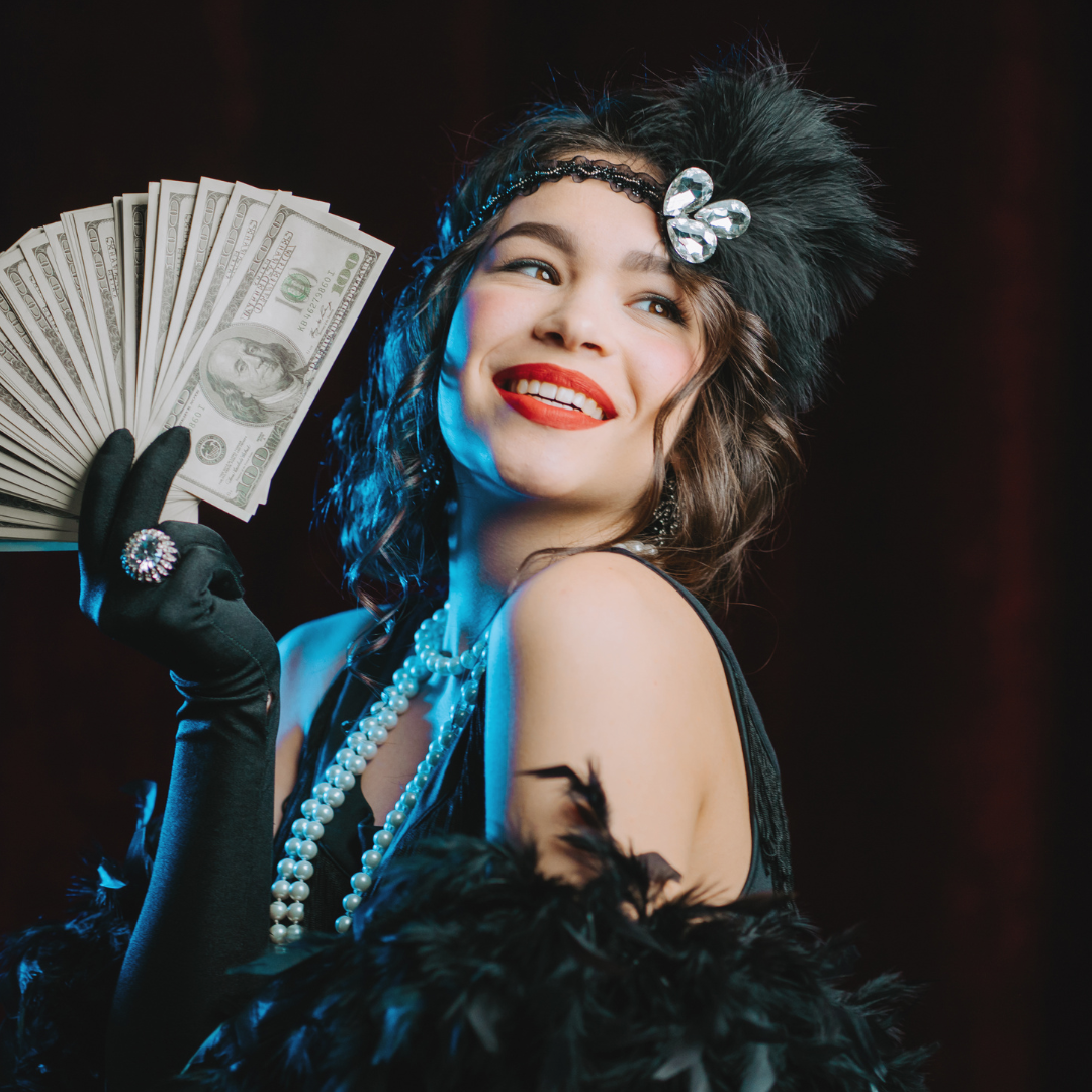 A woman in flapper attire smiles, holding cash. She wears a headband, gloves, and a feather boa against a red background.