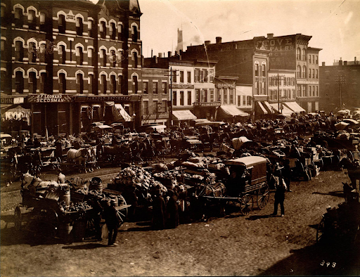 A black and white photo of a busy city street.