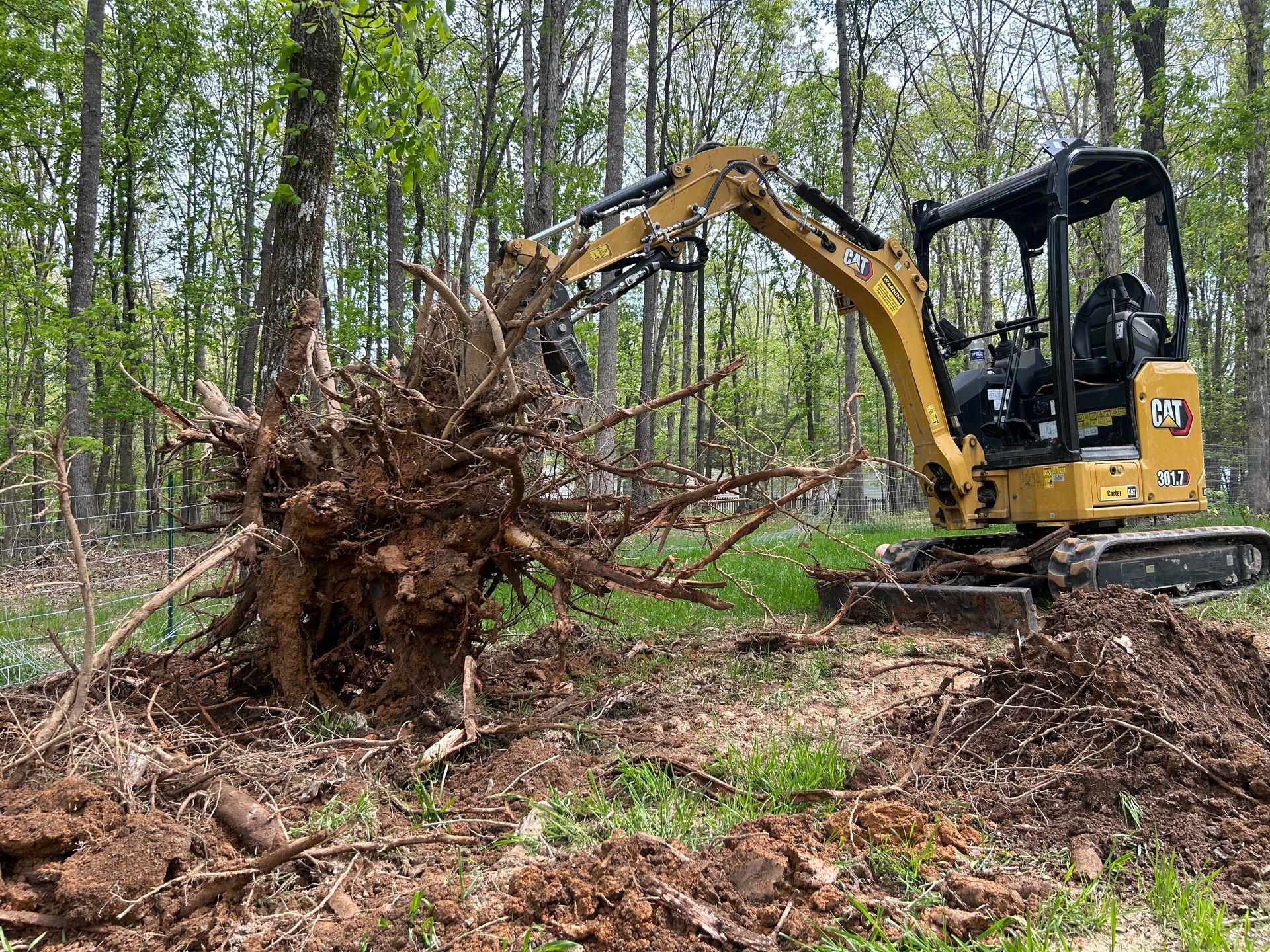 A red snowplow clears deep snow from a road during a winter storm.
