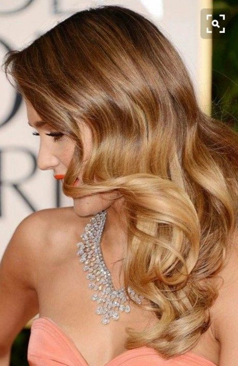 a woman wearing a pink dress and a diamond necklace