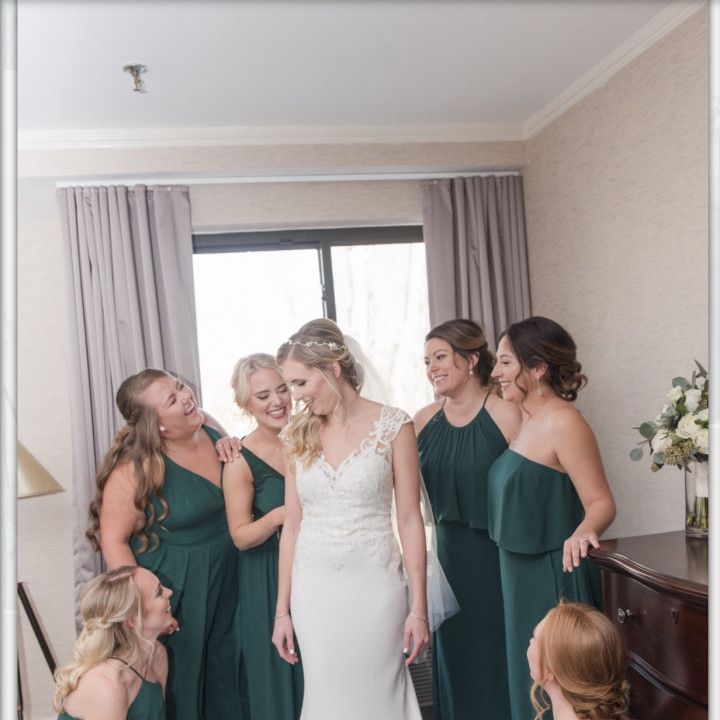 A bride and her bridesmaids are posing for a picture