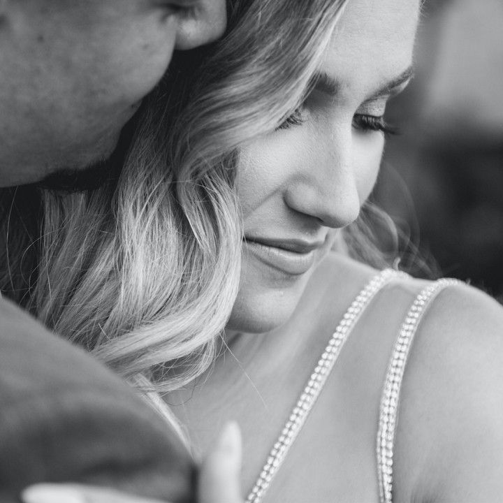 A man is hugging a woman in a black and white photo.
