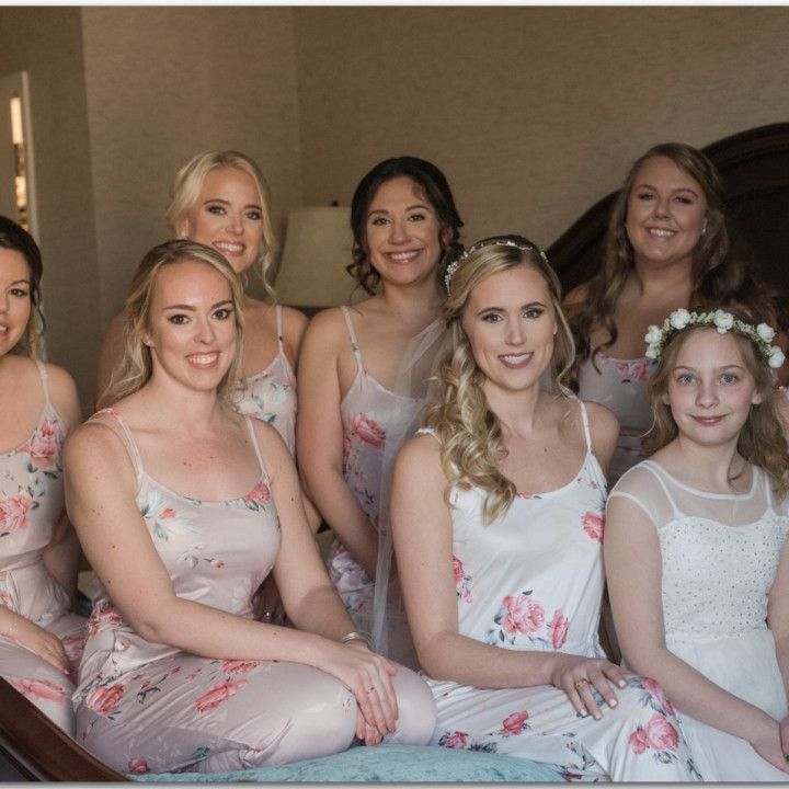 A group of women posing for a picture with one wearing a flower crown