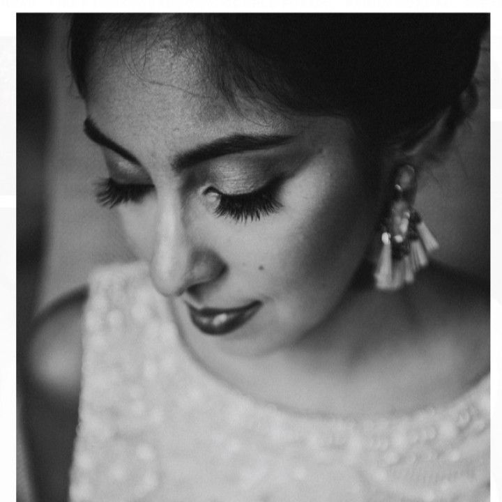 A black and white photo of a woman wearing earrings