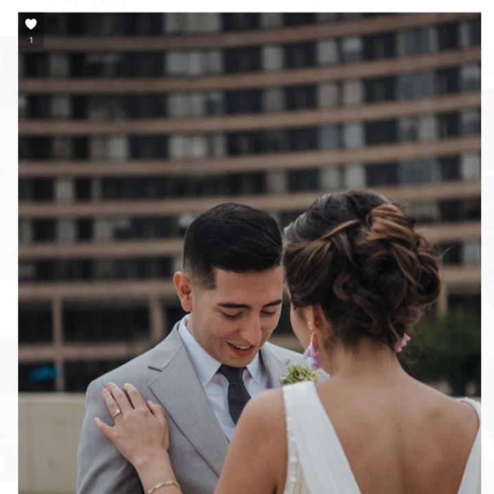 A man in a suit and tie stands next to a woman in a white dress
