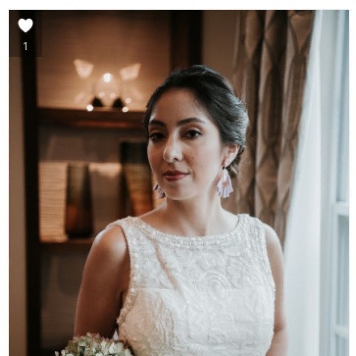 A woman in a white dress is holding a bouquet of flowers