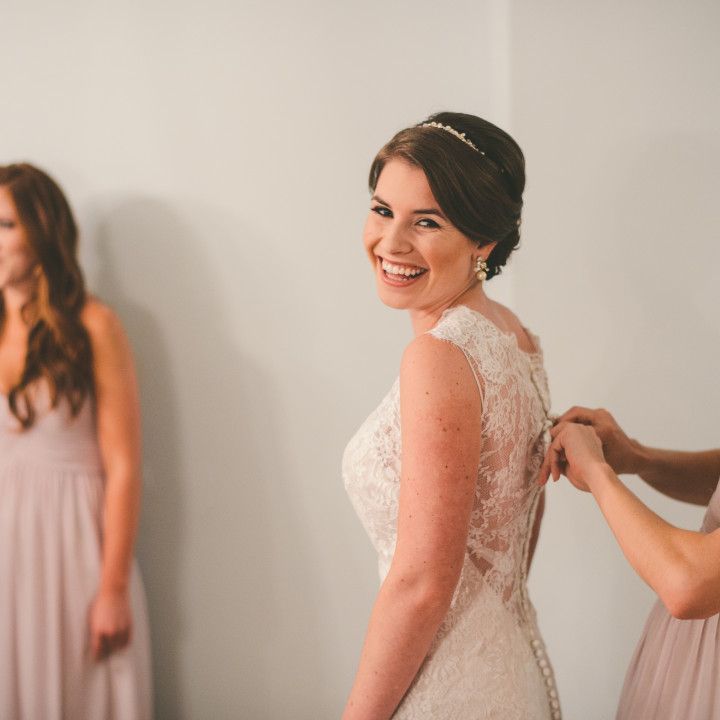 A bride and her bridesmaids are getting ready for her wedding