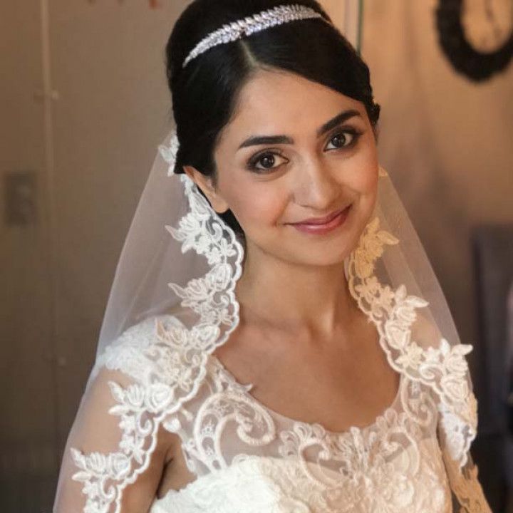A woman in a wedding dress with a veil on her head