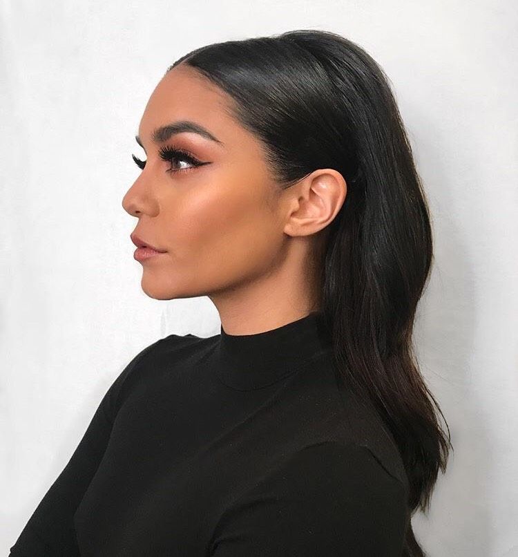 a close up of a woman 's face wearing a black shirt