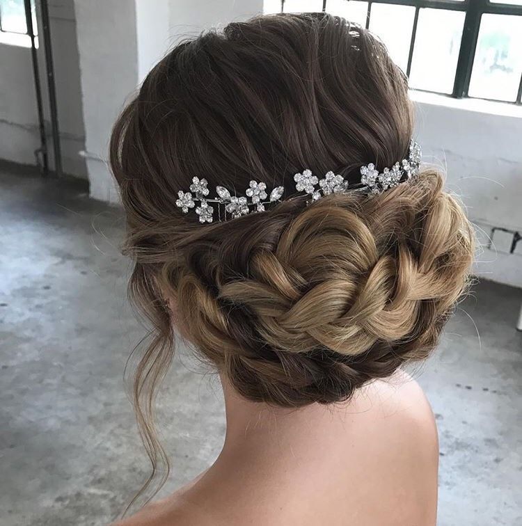 a woman wearing a braided bun and a headpiece