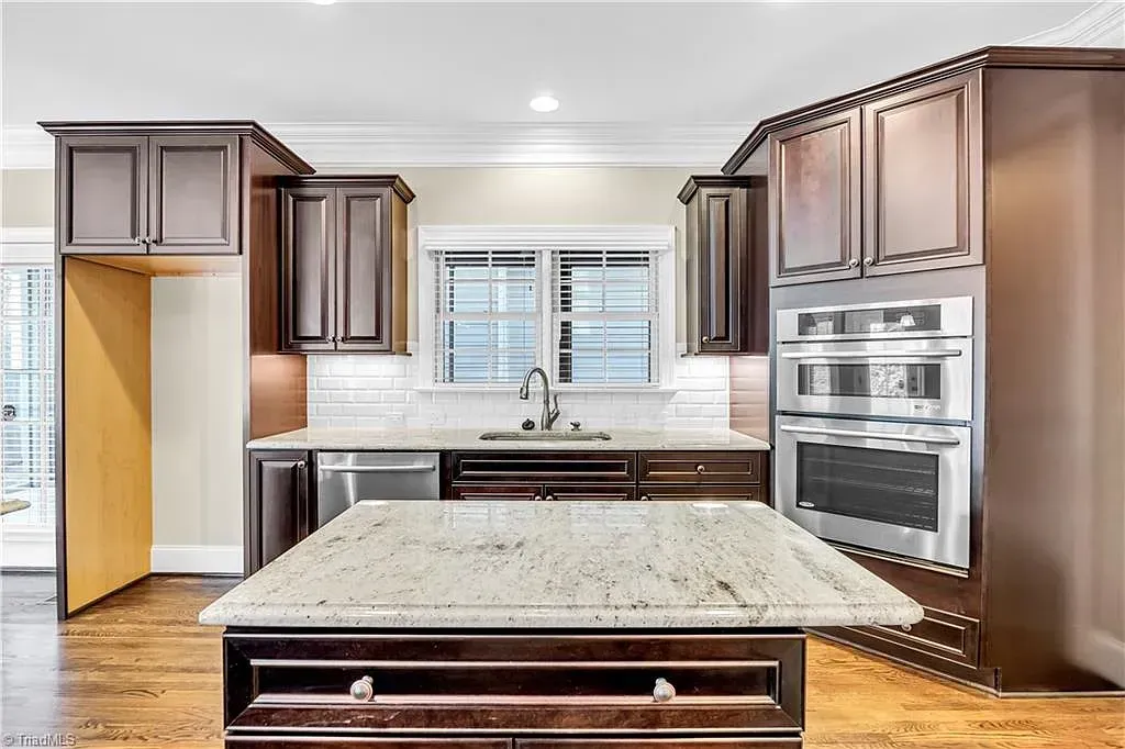 A kitchen with stainless steel appliances and granite counter tops.