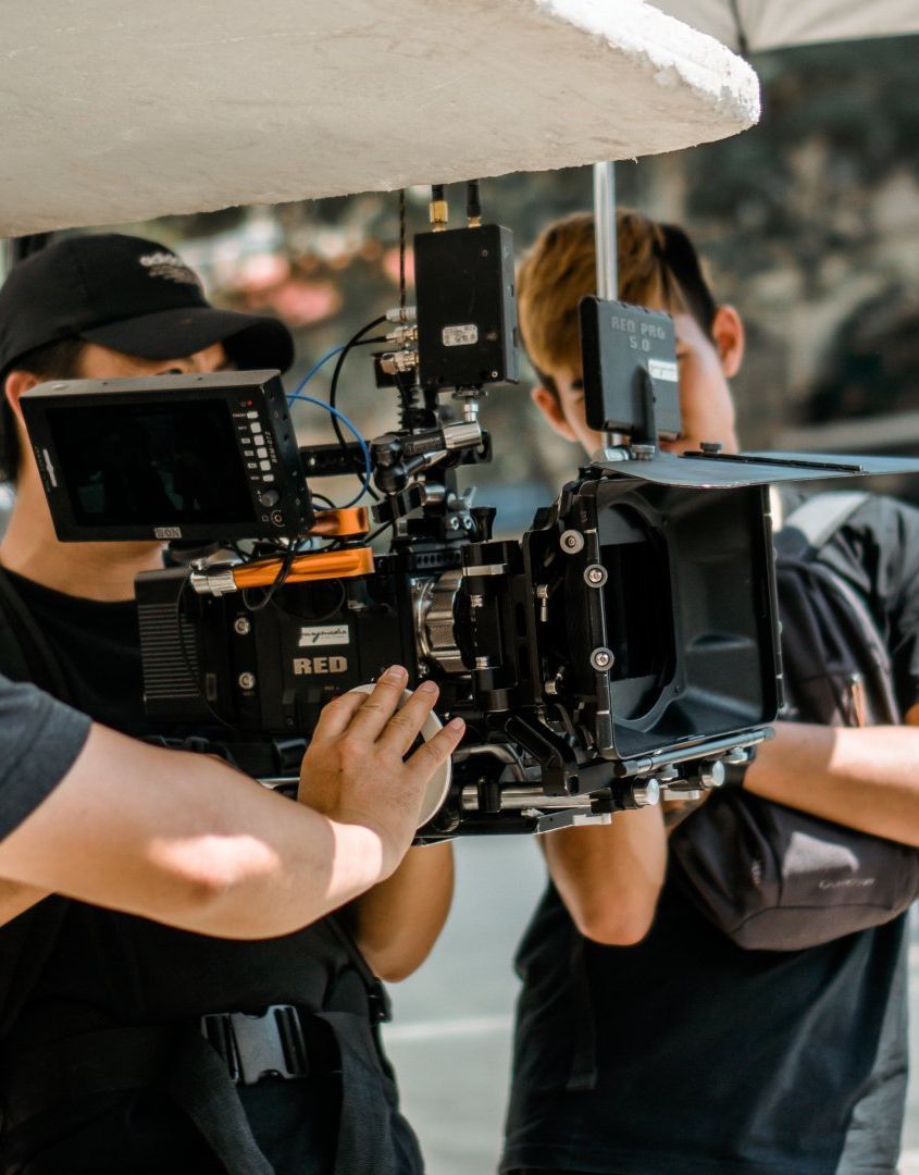 A man is holding a camera that says wcm on it