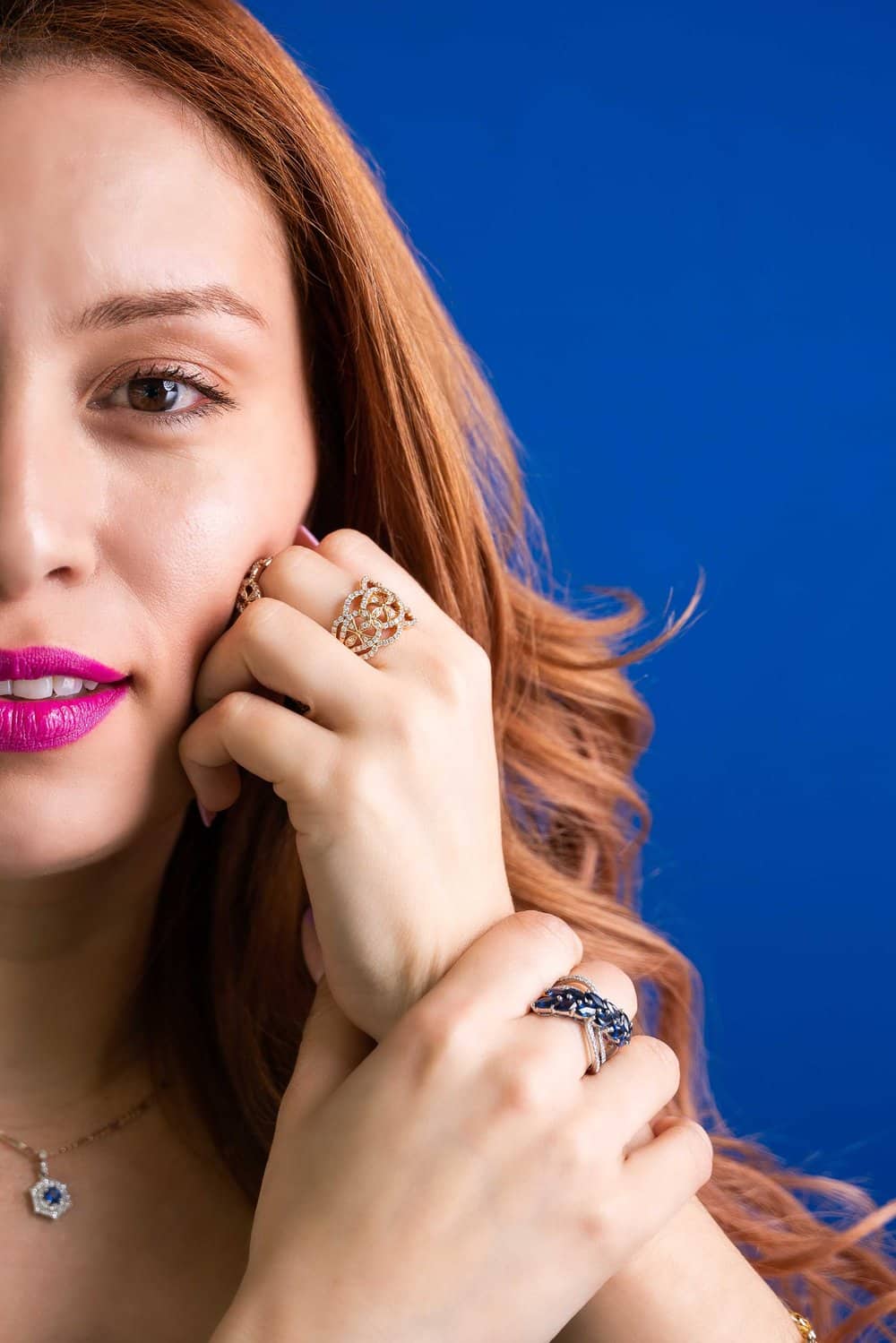 A close up of a woman wearing a ring on her finger.