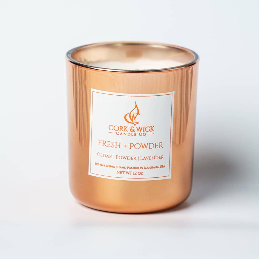 A copper colored candle from cork & wick candle co.