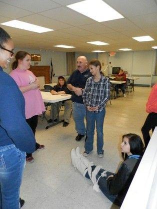 A group of people are standing in a room talking to each other
