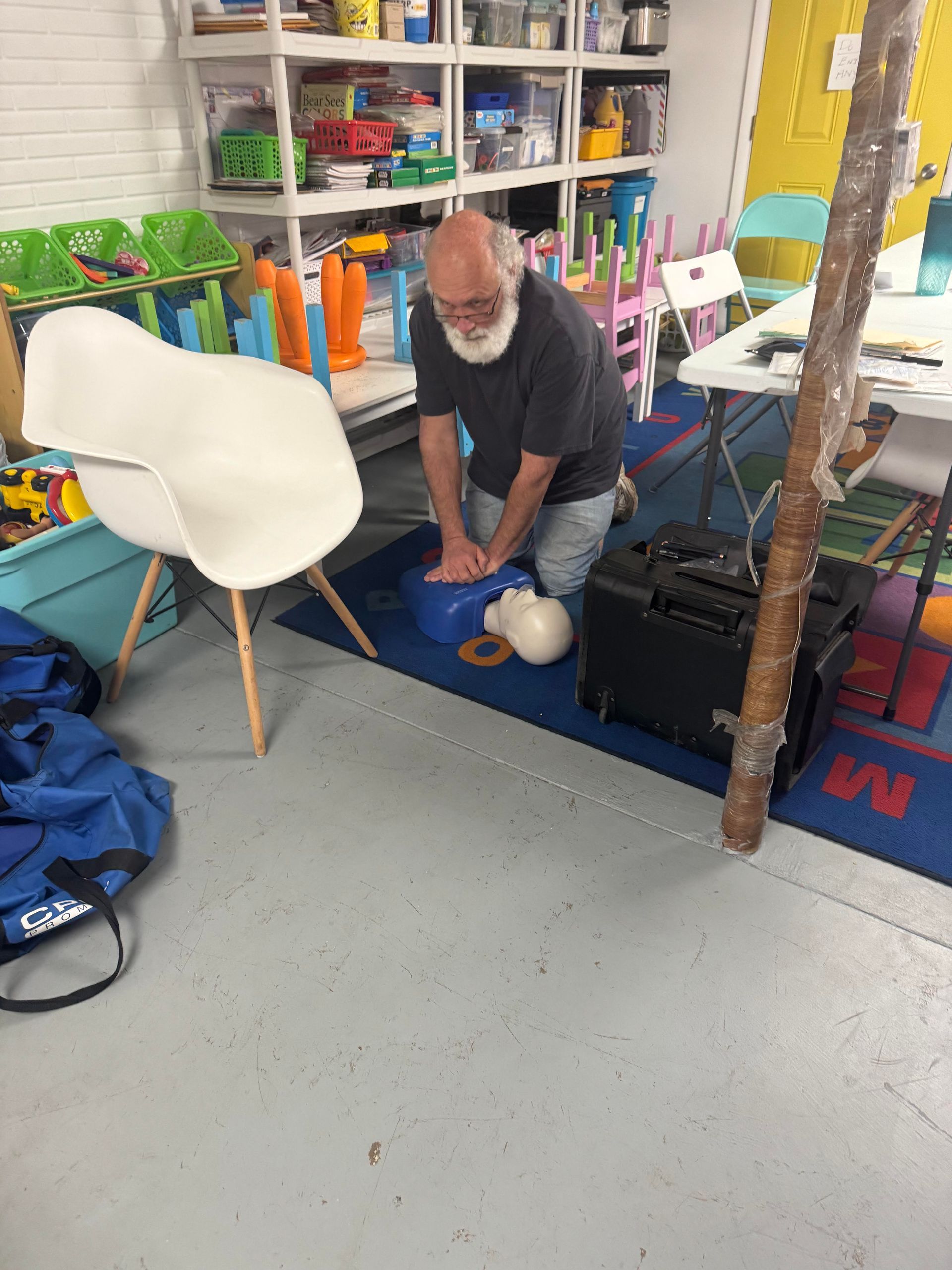 A man is doing a heart massage in a room.