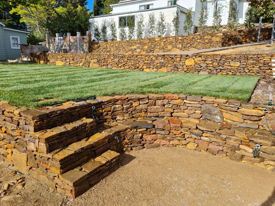 Retaining wall with stairs and turfed area