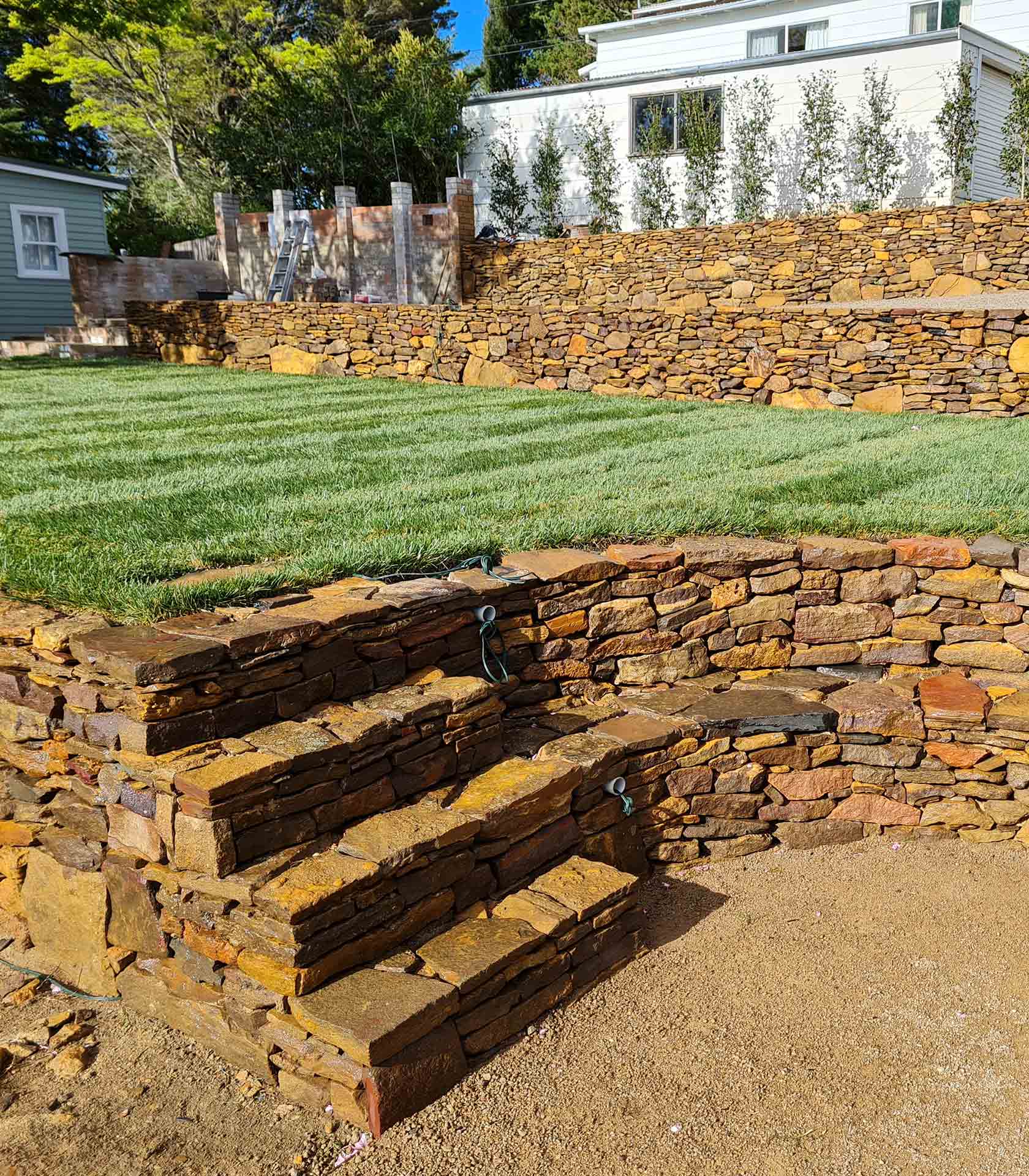 Retaining wall with stairs and turfed area