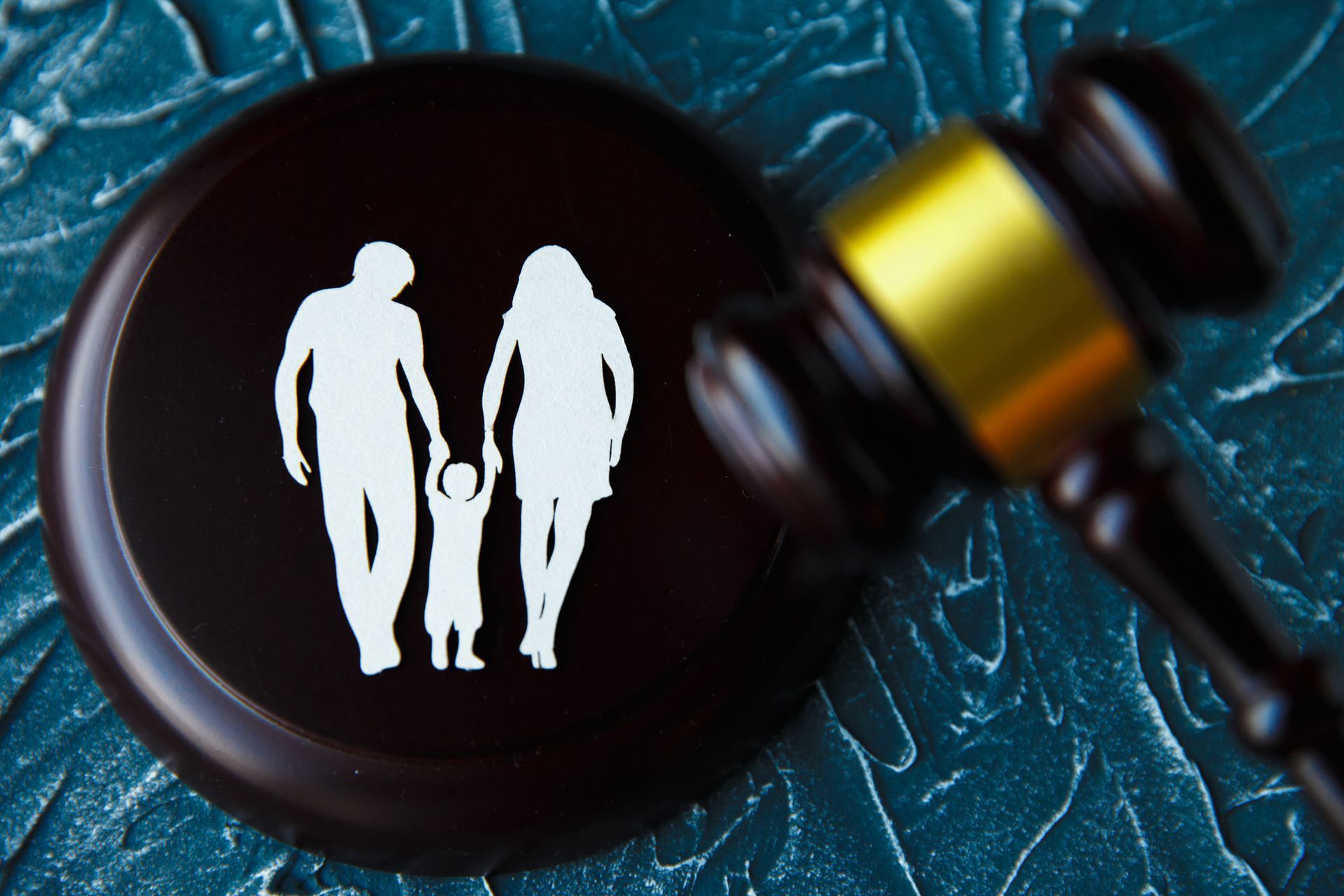 Family figure and gavel on table.