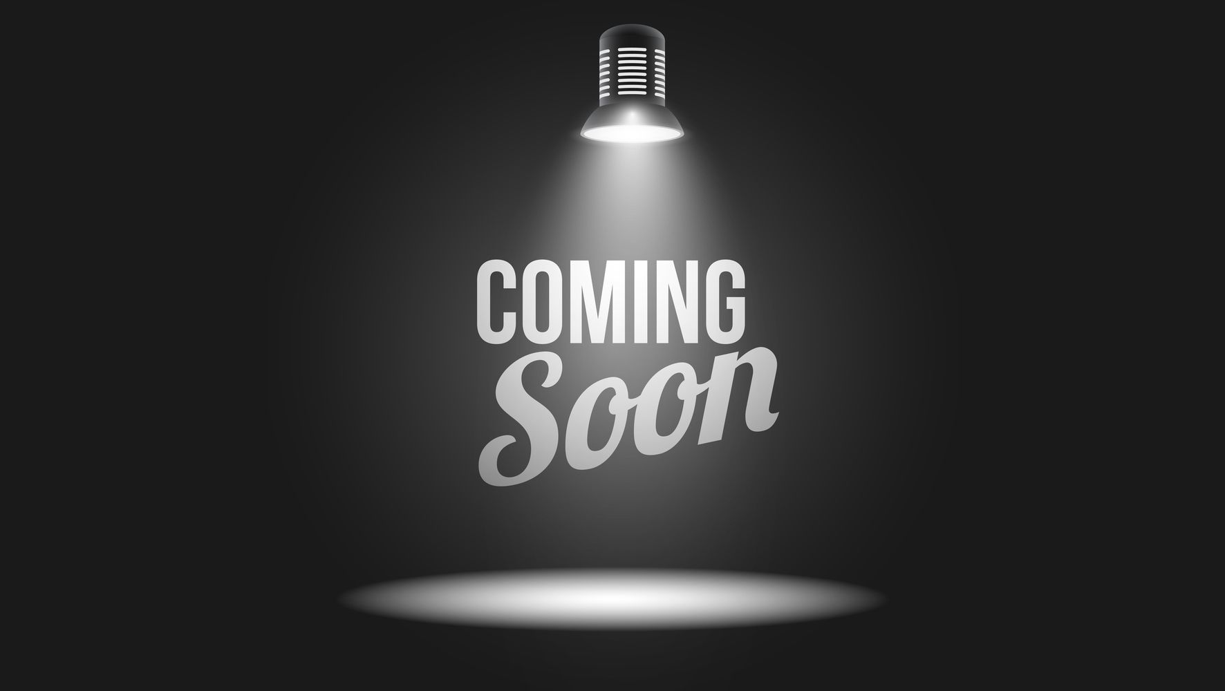 A light is shining on the word coming soon