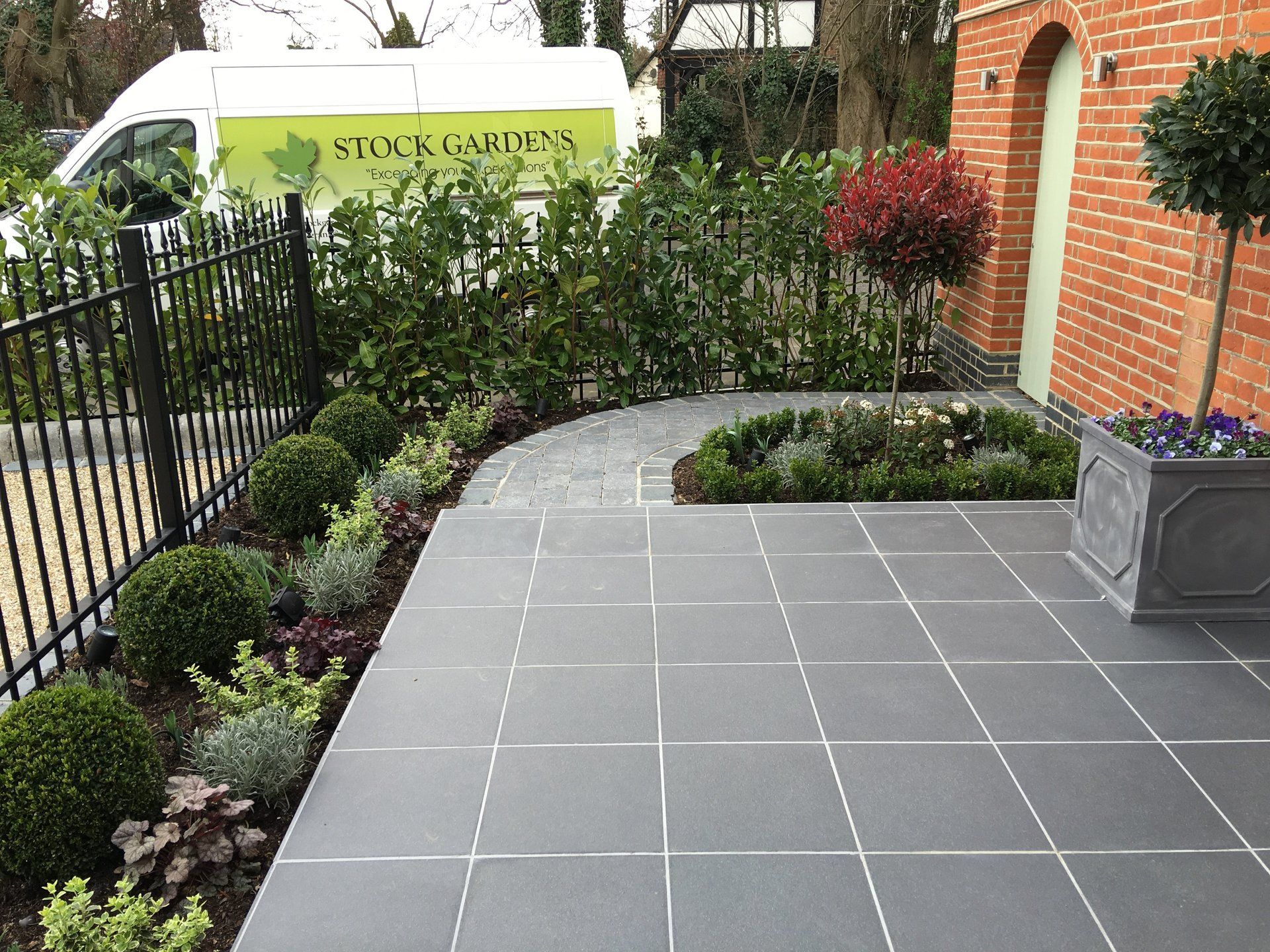 A brick building with a white van parked in front of it.