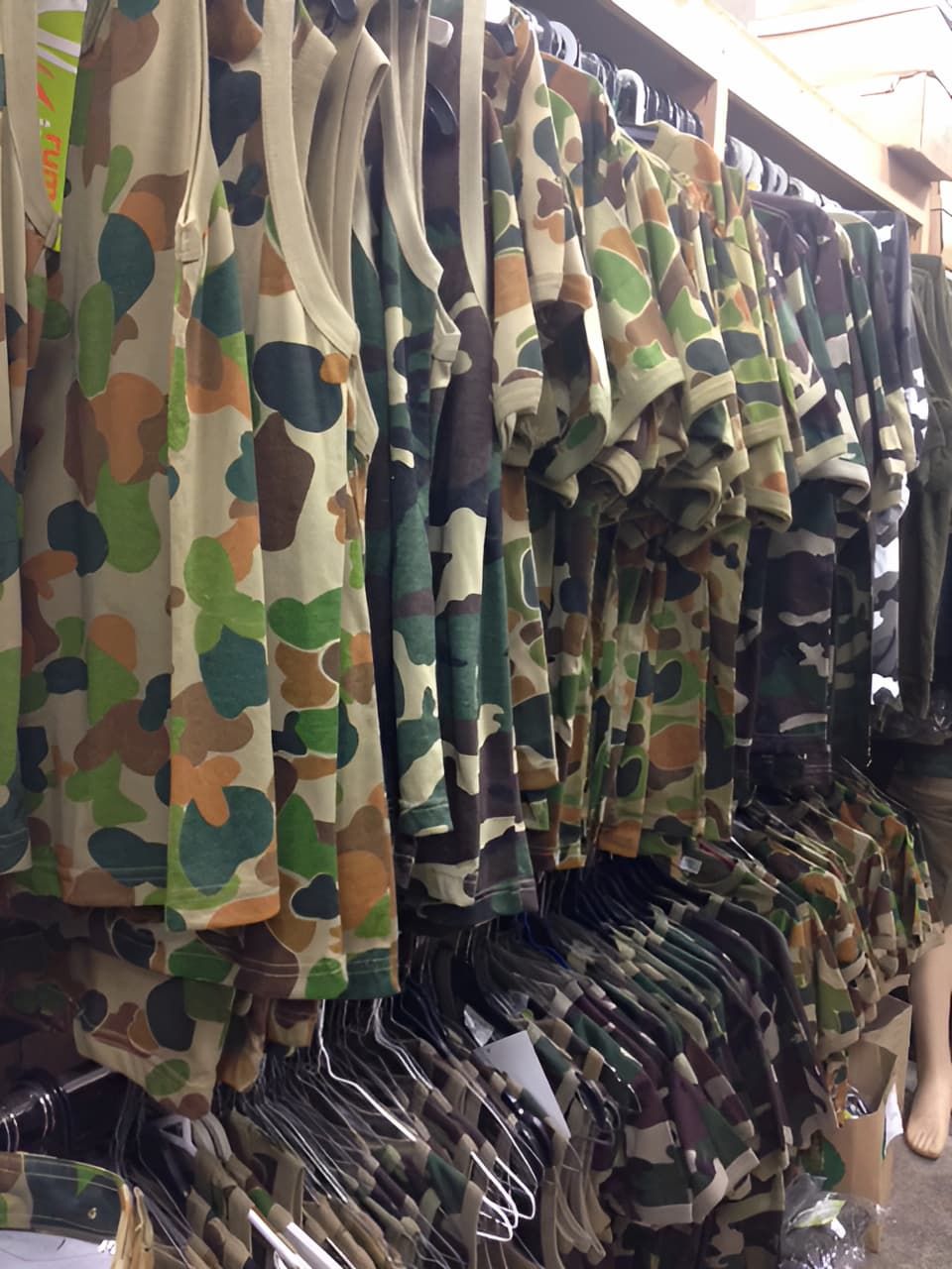 A Row Of Camouflage Shirts — Coffs Disposals, Workwear, Safety & Boot Centre in Coffs Harbour, NSW