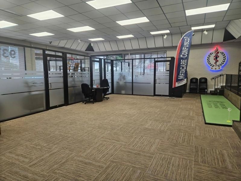Modern office interior featuring glass-walled partitions.