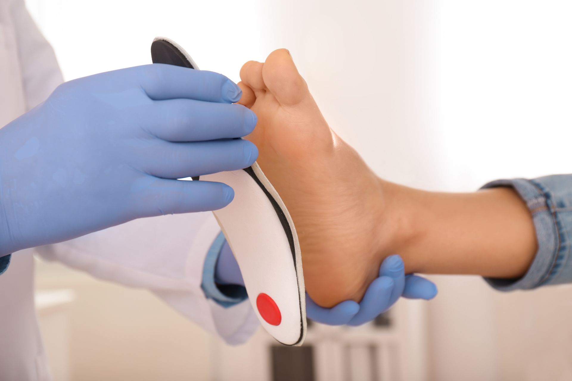 Person's Foot Being Assessed With an Orthotic — Biomedical Sports Podiatry in Forster, NSW