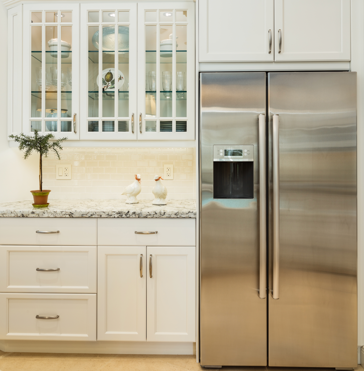 A man is fixing a microwave oven on a table.