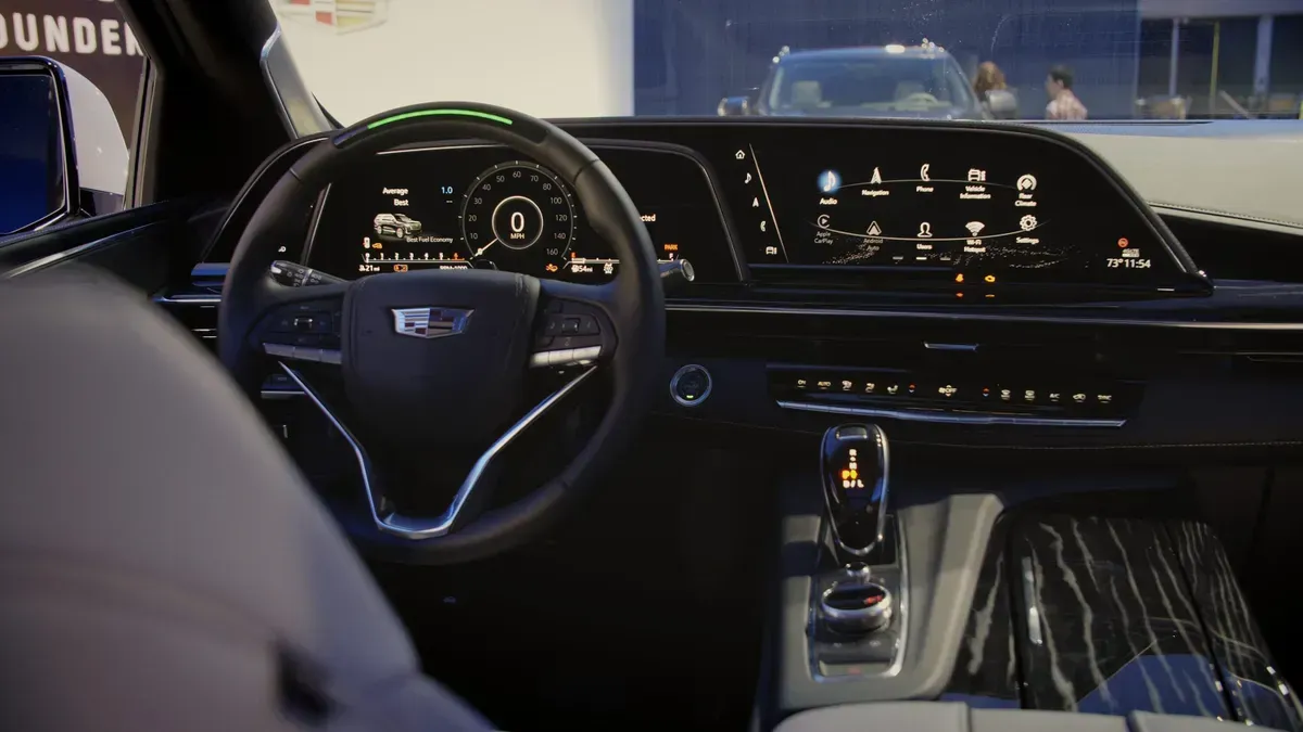 The inside of a car with a steering wheel and dashboard