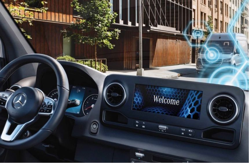 A car dashboard with a welcome screen on it