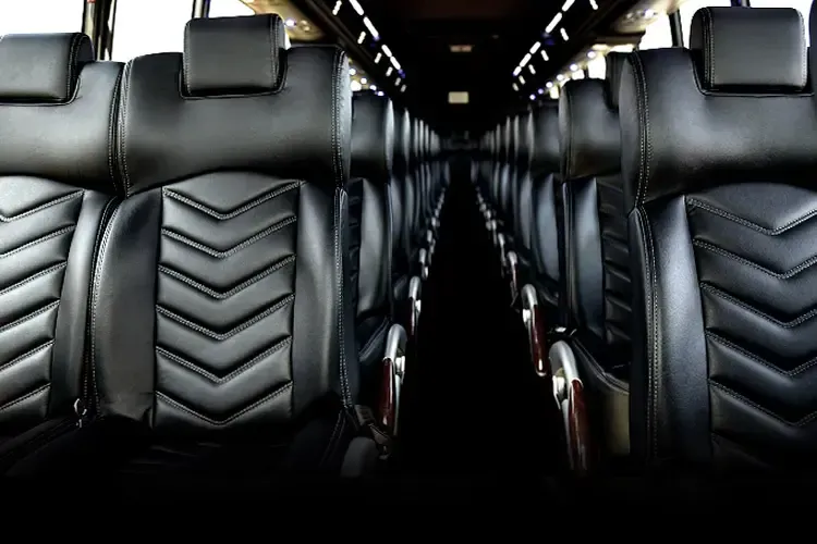 A row of black leather seats on a bus