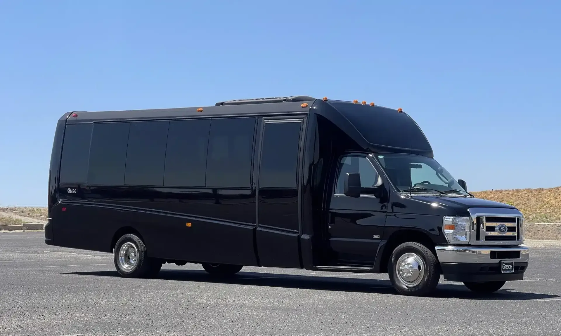 A black van is parked on the side of a road.
