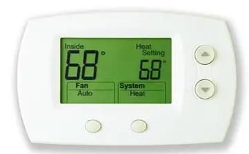 White thermostat with a green display showing 
