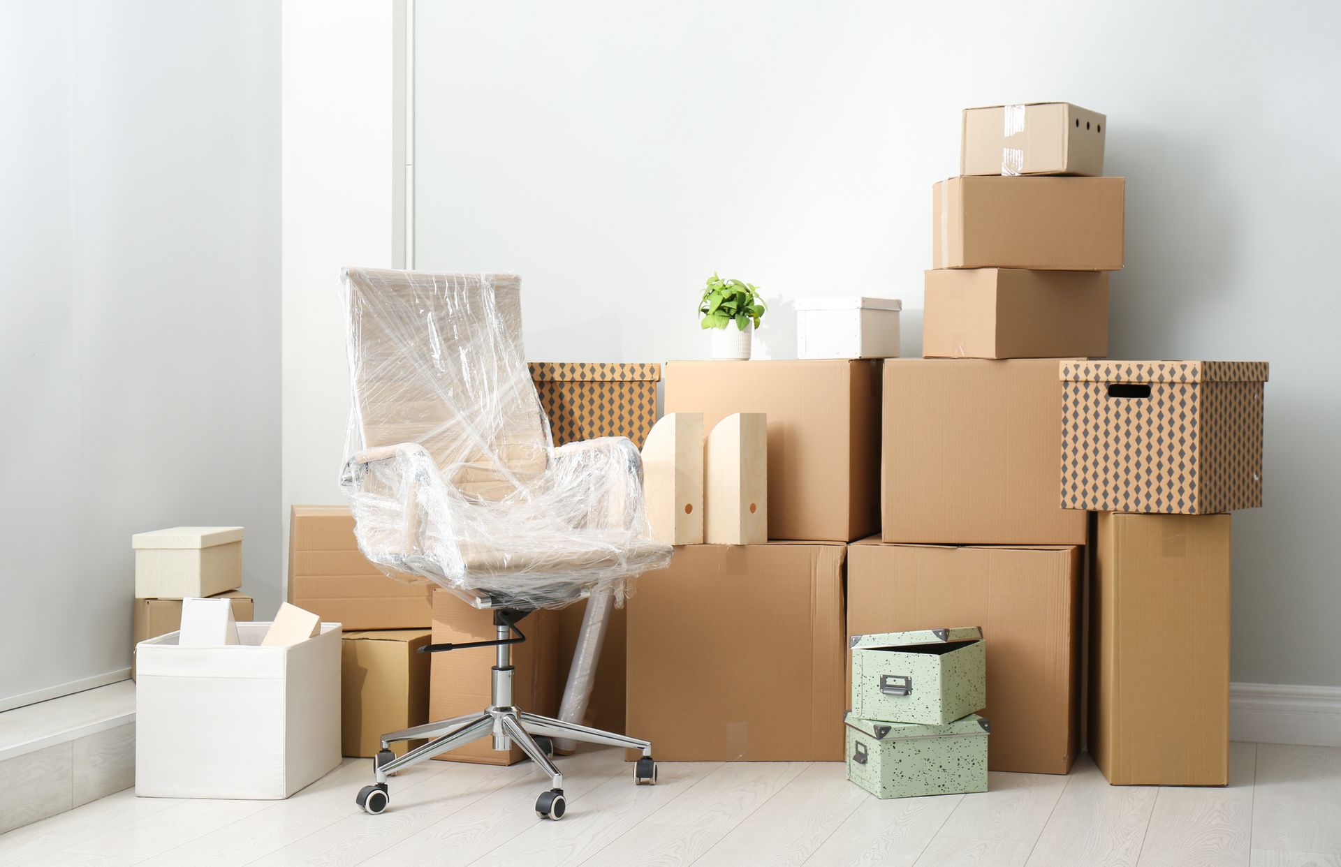 Boxes and chairs packed indoors, perfect for furniture storage service.